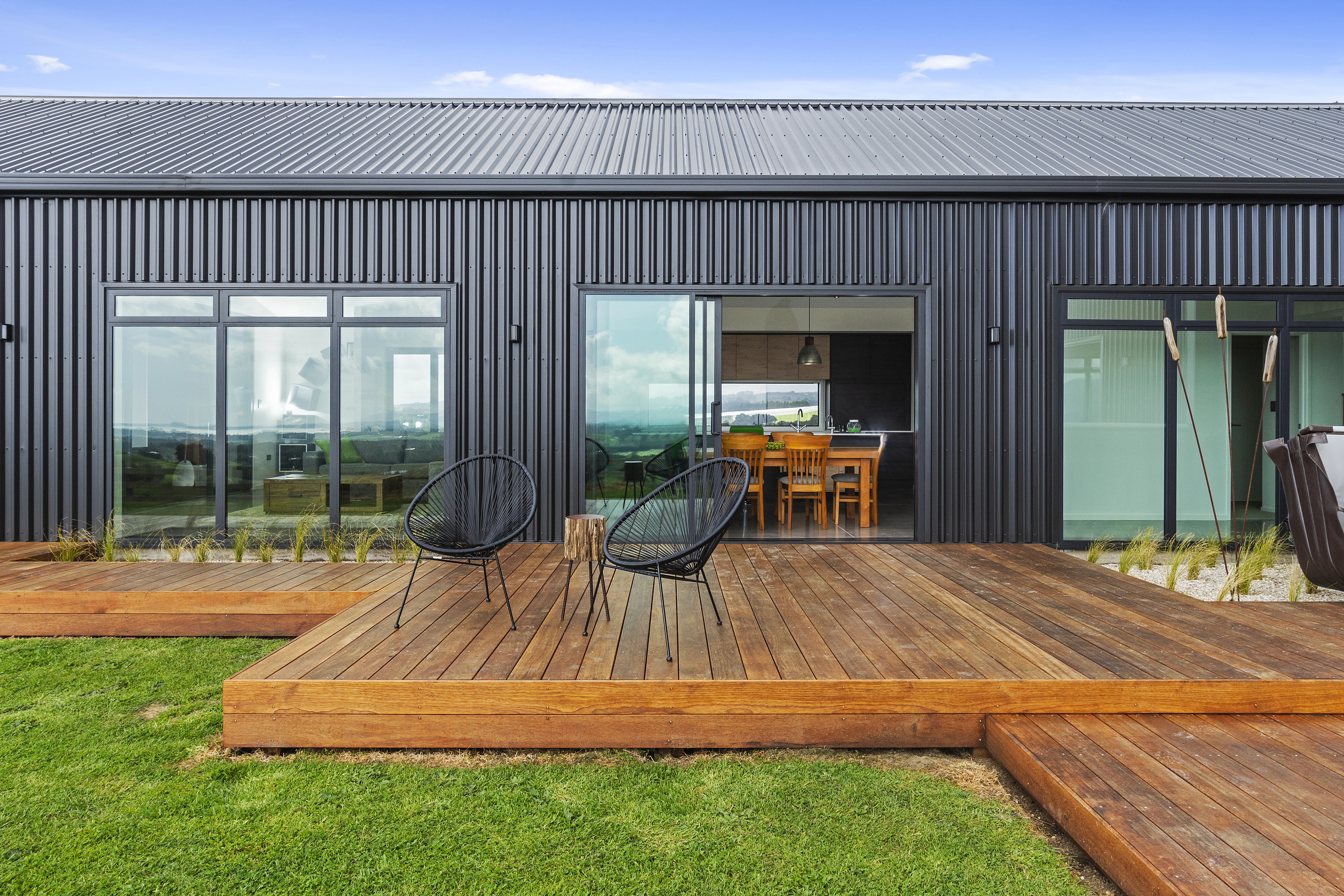 Modern house with glass doors wooden patio and new roof