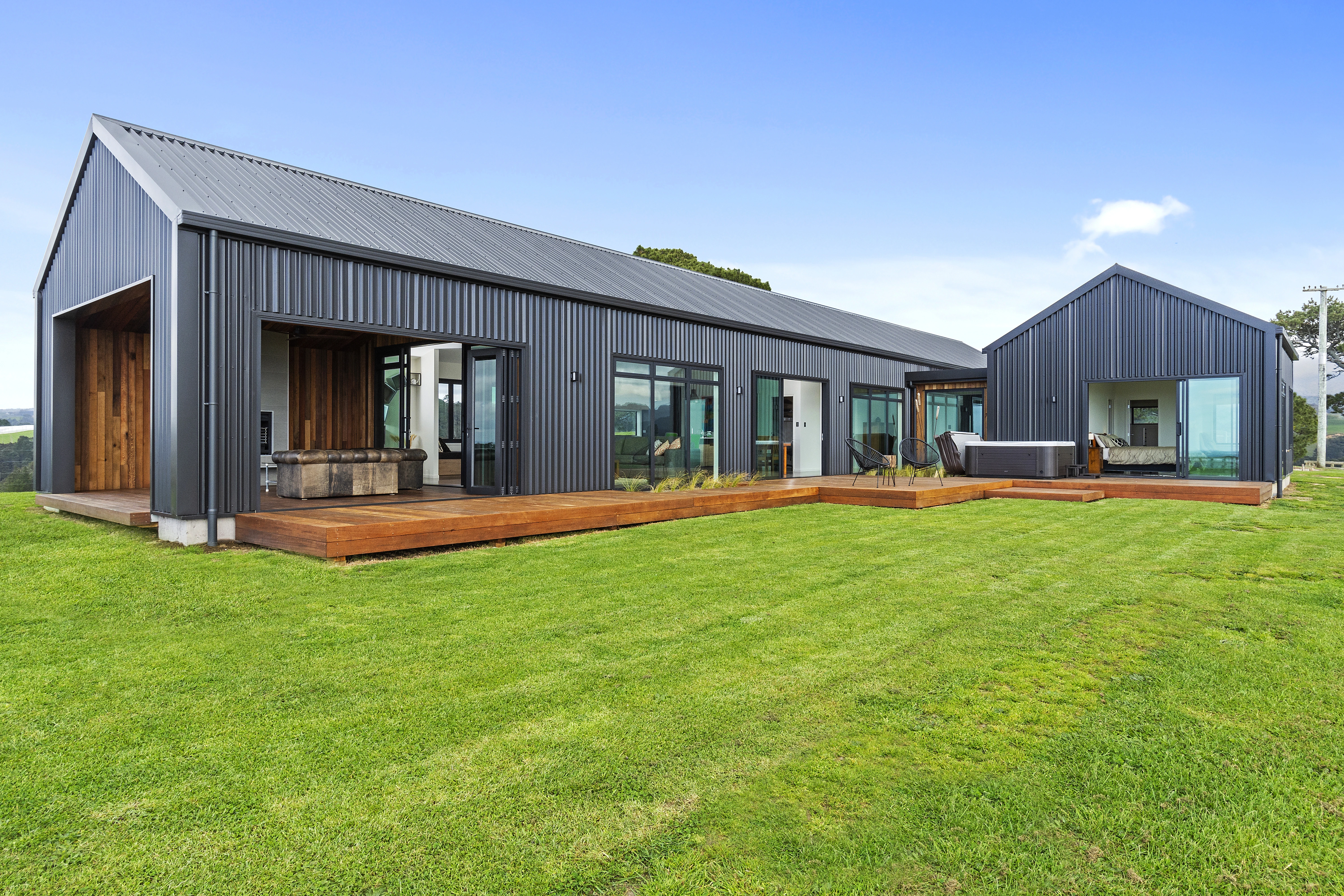 Modern house with glass doors wooden patio and new roof