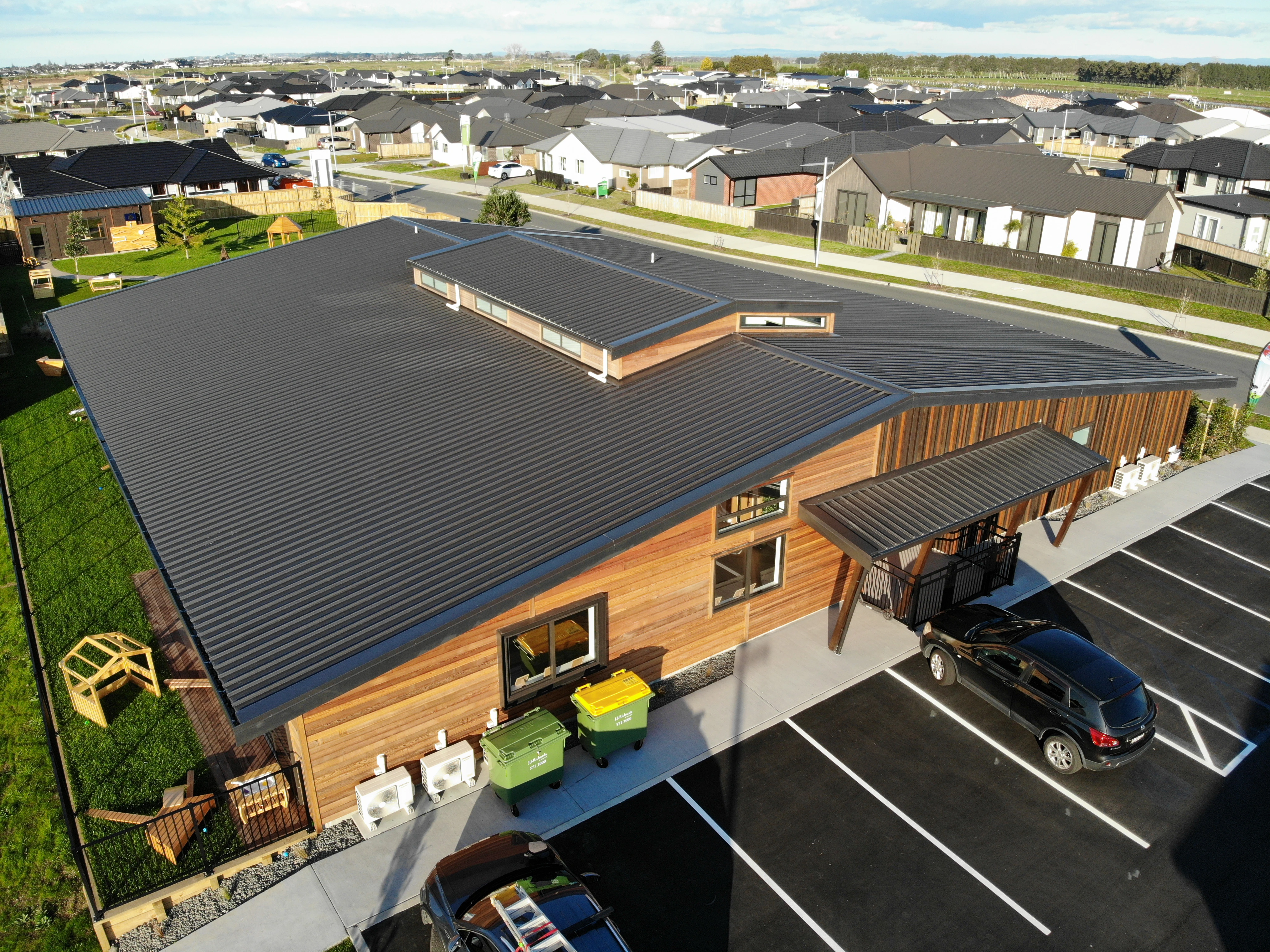 Commercial Building with new roof with parked car in front